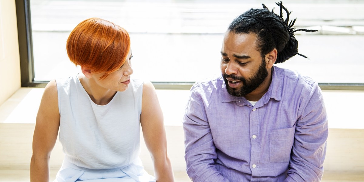 two seated people talking